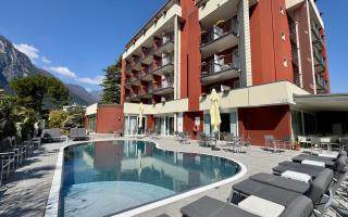 Modern hotel with pool and mountain view.