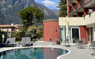 Modern pool with mountain view and clear blue sky.