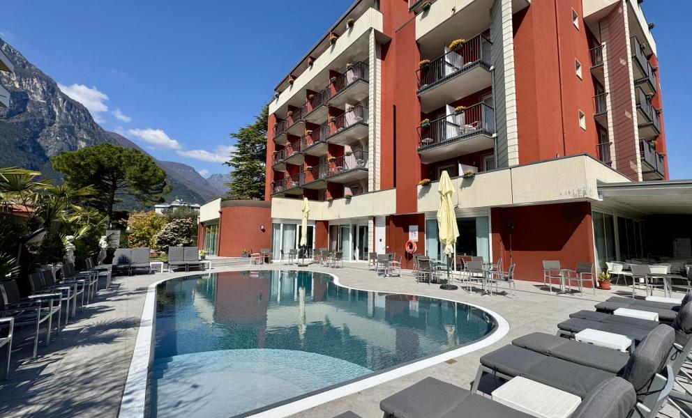 Modern hotel with pool and mountain view.