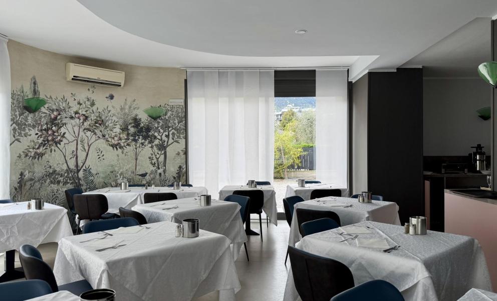 Elegant restaurant with floral decorations and set tables.