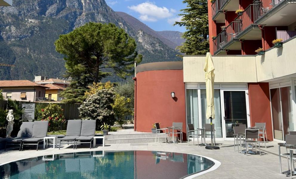 Modern pool with mountain view and clear blue sky.
